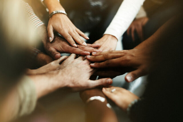 A picture of different hands joining togetherc