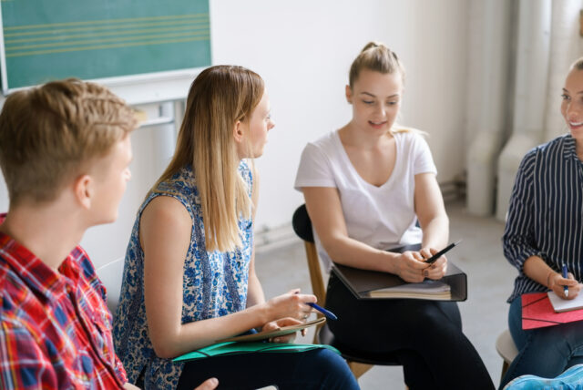 a photo of people studying in a circle